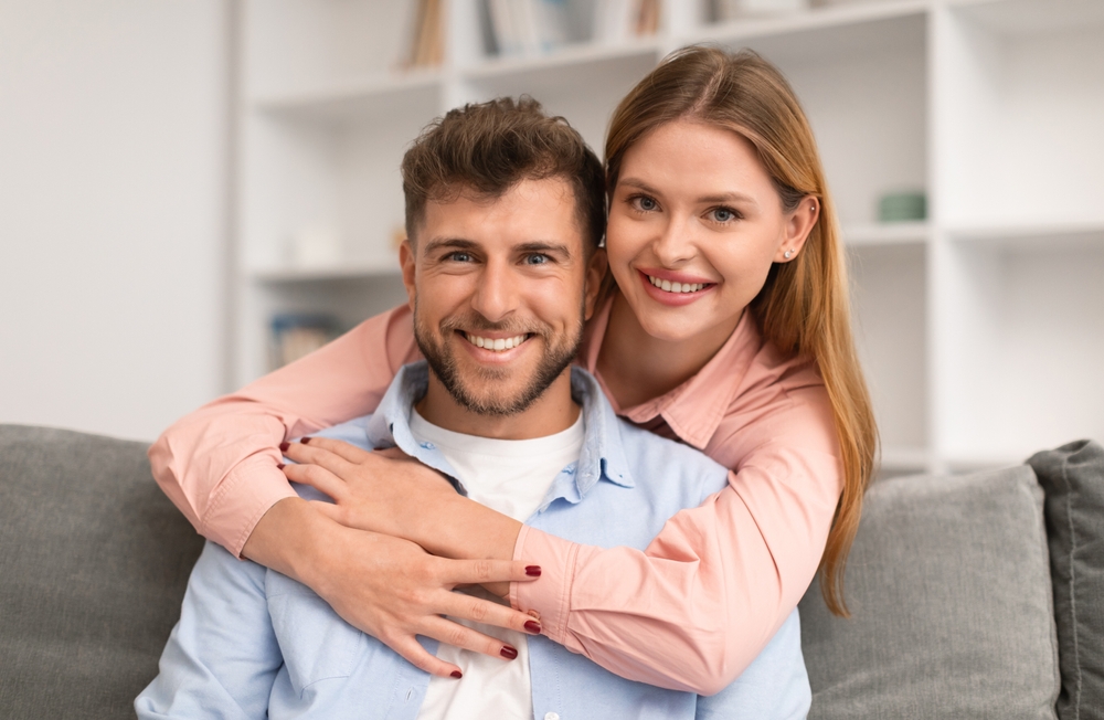 Smiling Caregiver and Senior Patient Sharing Warm Embrace – Loving Dentistry